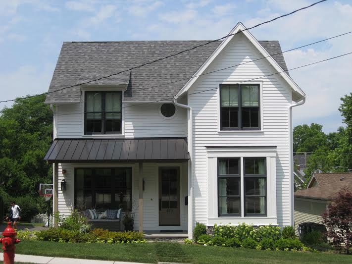 Home with new roofing, gutters, and siding installed