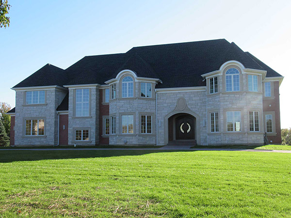Architectural asphalt shingle roof on a stone and brick home in South Barrington, Illinois